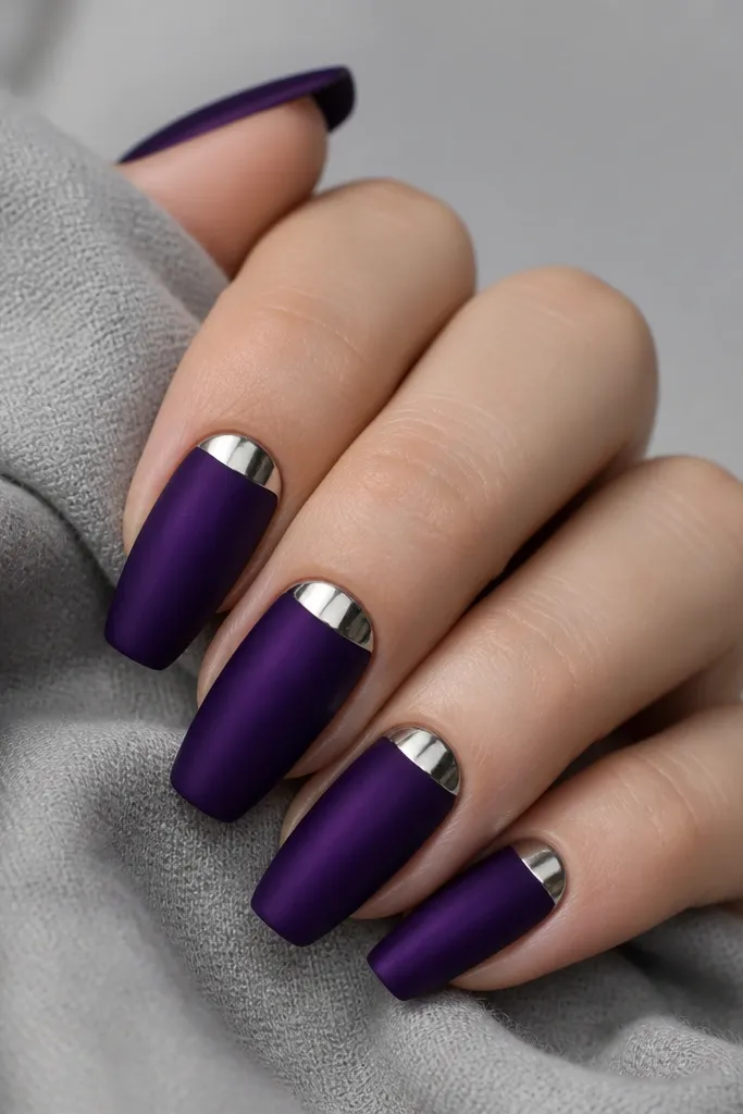 Medium coffin nails with a matte-to-satin dark purple base. At the cuticle, a crisp mirror silver half-moon sits on each nail, reflecting light sharply.