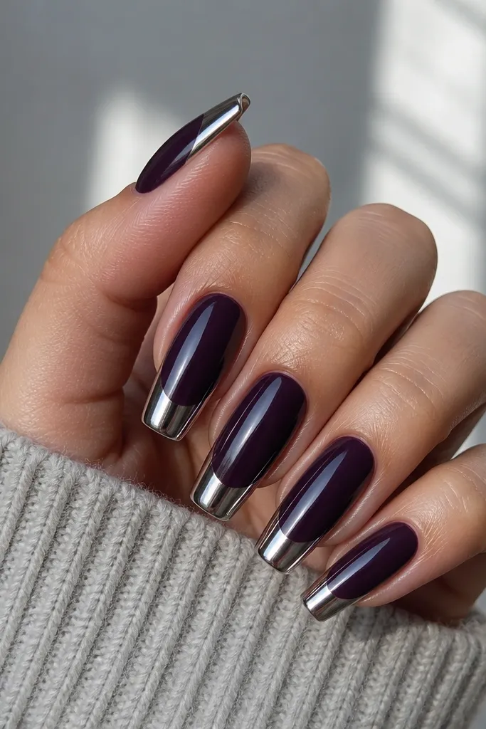 Coffin nails with a glossy dark purple base. The tips are coated in a mirror silver chrome that wraps slightly over the sides.