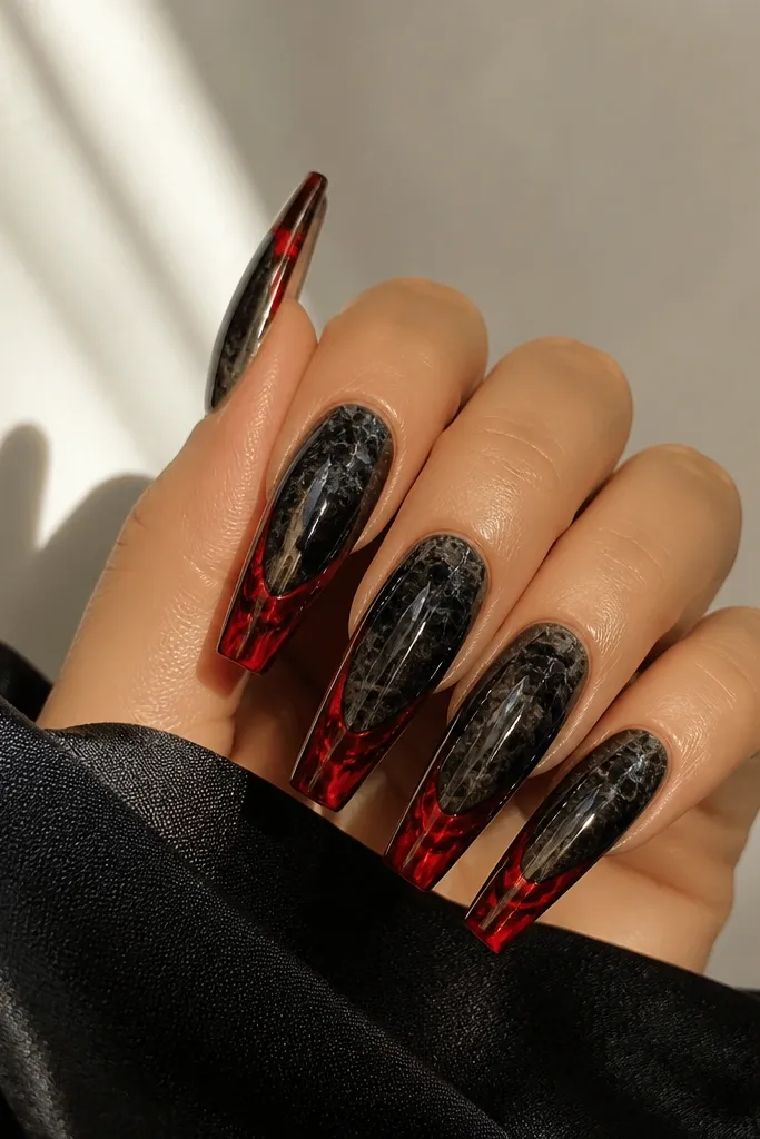 Long coffin nails with a black marble effect in glossy finish. The free edge is outlined with a French smile in black, and a red vein-like line runs through the center of the red tip area. The red looks like liquid ink against black.