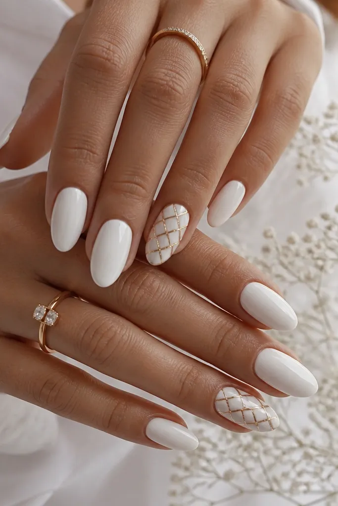 Most nails are plain glossy white. Two accent nails have a diagonal checker pattern made from tiny white squares separated by thin gold lines, placed near the center. The rest of the nails stay clean and simple.