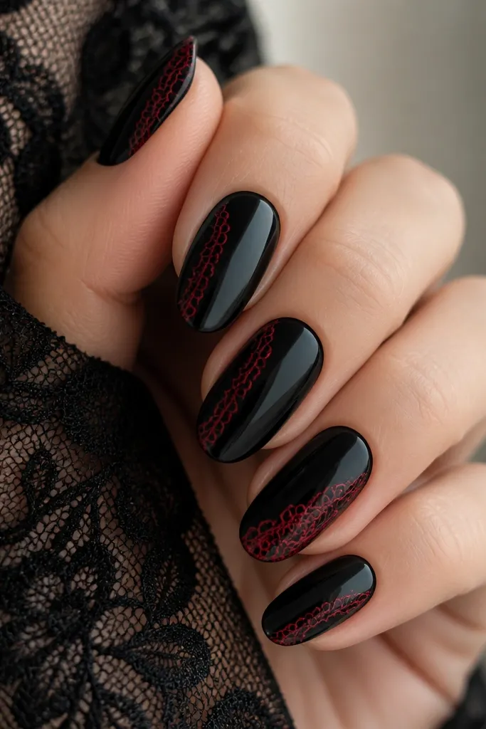 Glossy black nails with a thin red lace-trim pattern along one side of each nail, like a vertical border. The lace lines are delicate, with small loops and curls. One nail has a fuller lace segment near the tip.