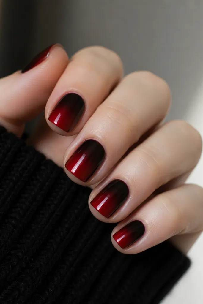 Short square nails; red is strongest at the tip and fades into black toward the base, with a smooth gradient and glossy finish.