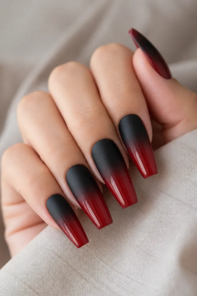 Coffin nails split by finish: the black half is matte, the red half is glossy, with a smooth horizontal fade between the finishes.