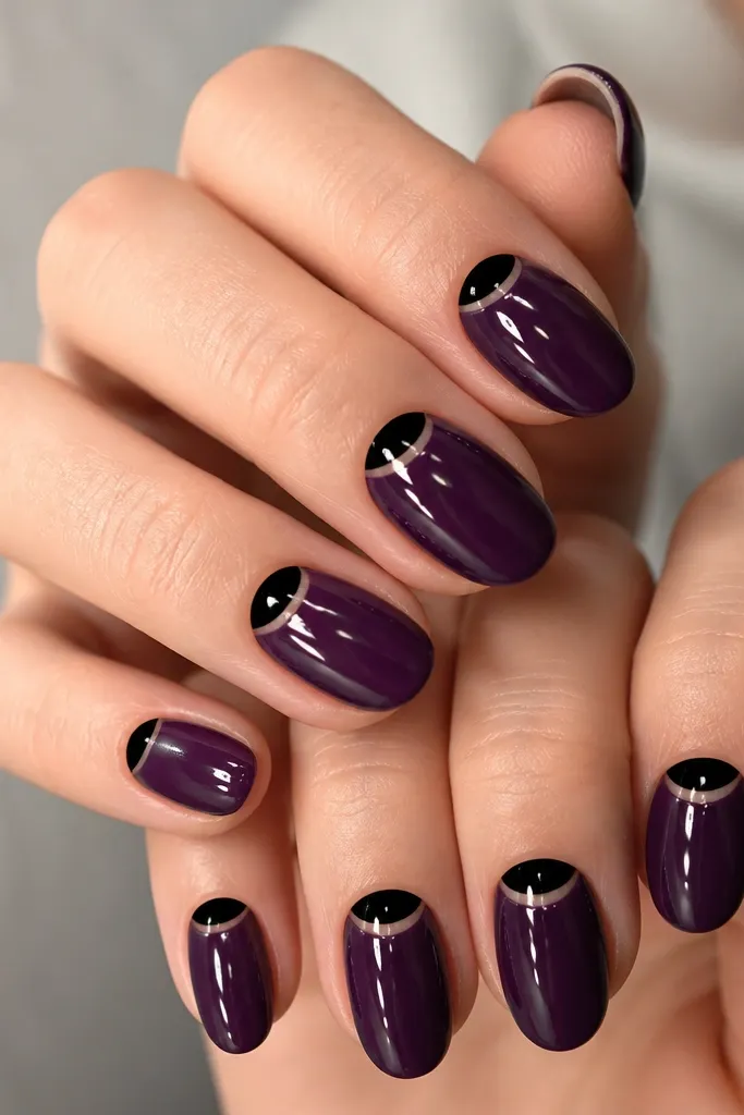 Dark purple jelly nails with a glossy look; the cuticle area is left clear-ish and filled with a bold black half-moon on each nail, creating a crisp crescent at the base.