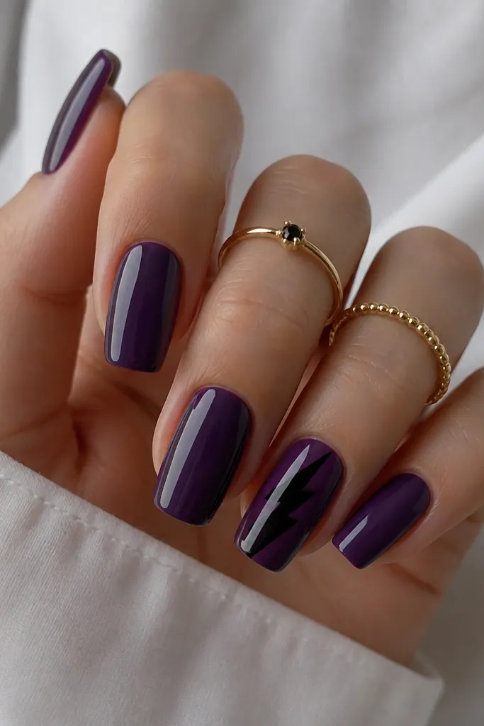 Most nails are deep stormy purple with a glossy finish; one or two accent nails have a sharp black lightning bolt across the center.