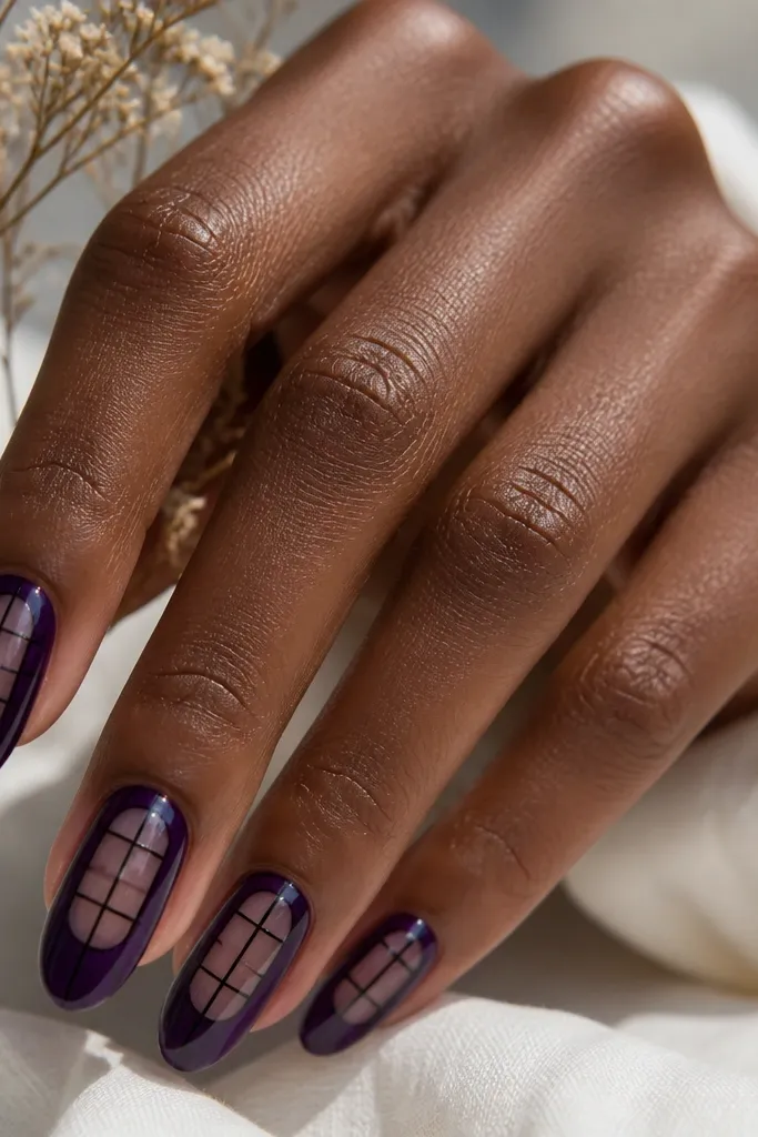 Deep purple nails with small clear windows at the center; black crosshatch lines form a grid over the clear and purple areas, finished glossy.