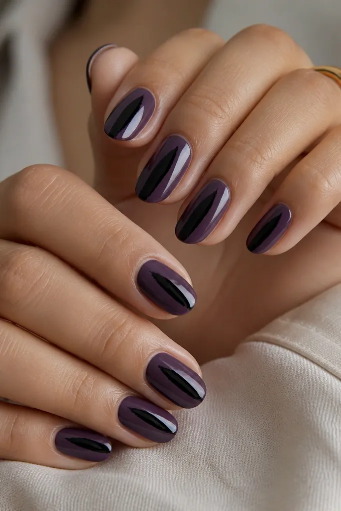 Deep purple creme nails with a single bold black brushstroke across the center of each nail; glossy finish makes the stroke look smooth and graphic.
