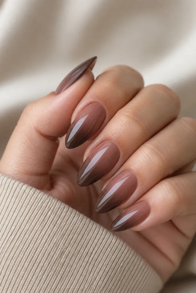 Almond nails with a gradient from rose-brown near the cuticle into deeper chocolate at the tip; glossy and smooth, no hard lines.