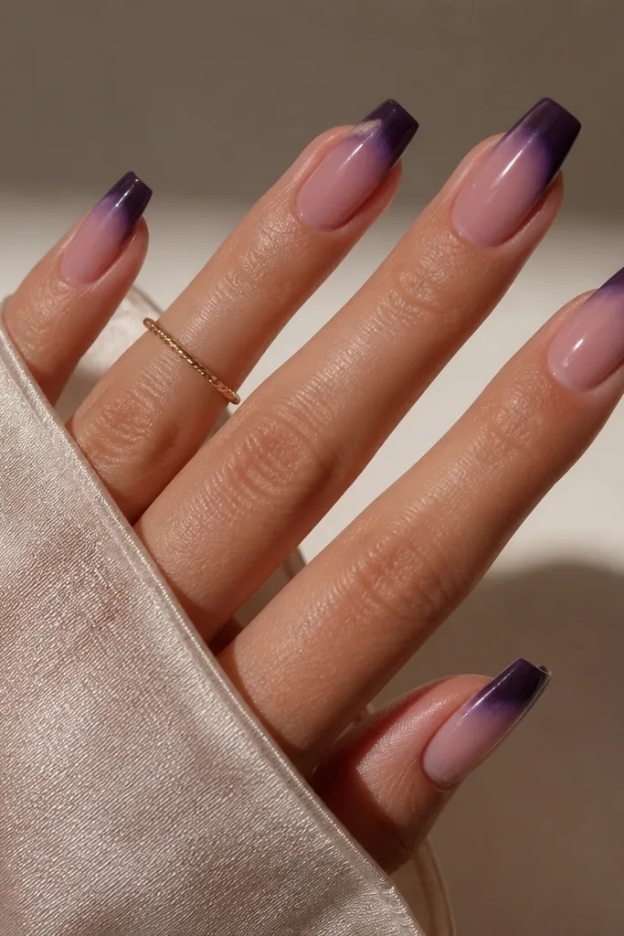 Medium coffin nails with sheer rose base; the tips are blackened violet with a slightly smoky gradient at the edge; glossy top.