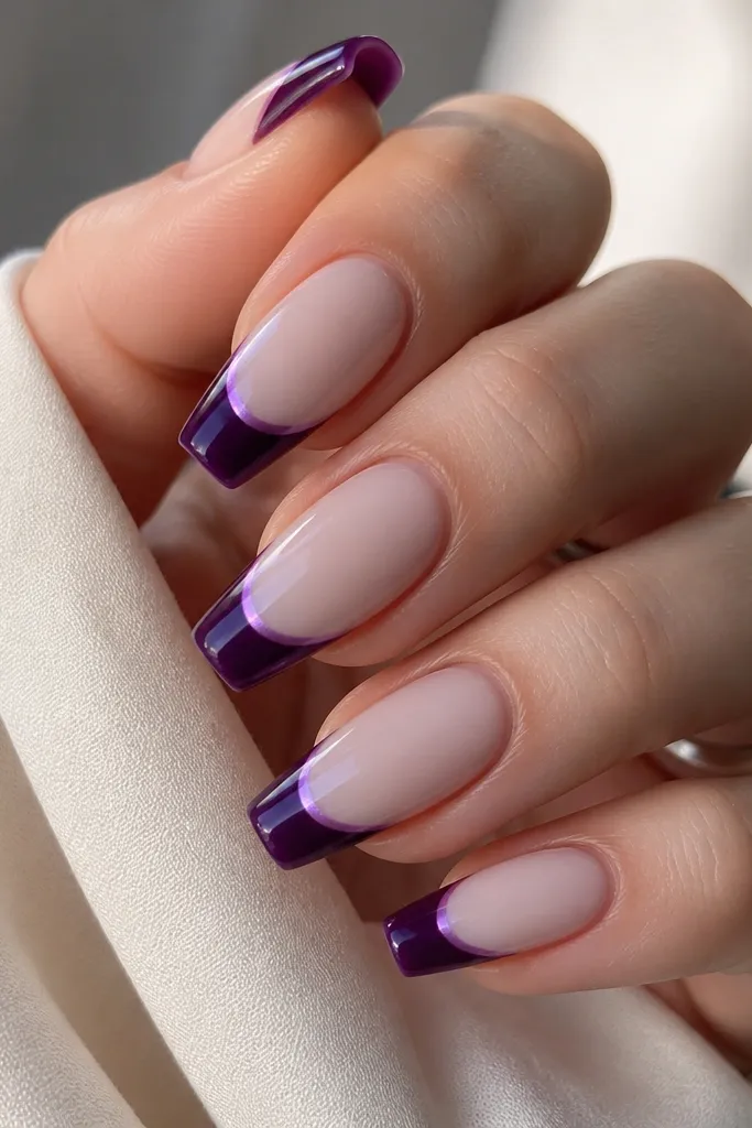 Medium coffin nails with milky nude base; dark purple French tips with a subtle color-shift edge that looks slightly lighter at the border; glossy finish.