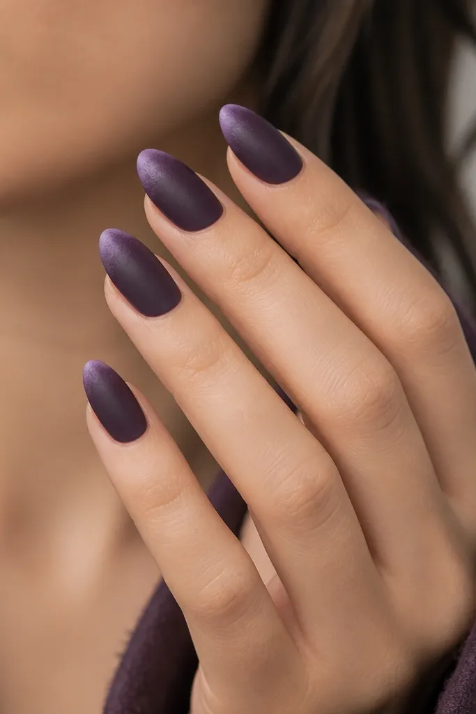 Almond nails with dark purple base and a slightly softer, dusty gradient at the tips, like powdered velvet, matte finish.