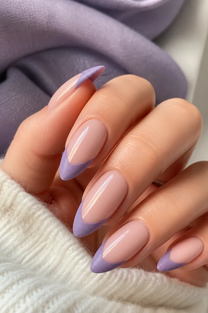Almond nails with nude center and soft purple velvet-finish French tips, leaving the middle clear and the tip dusty matte.