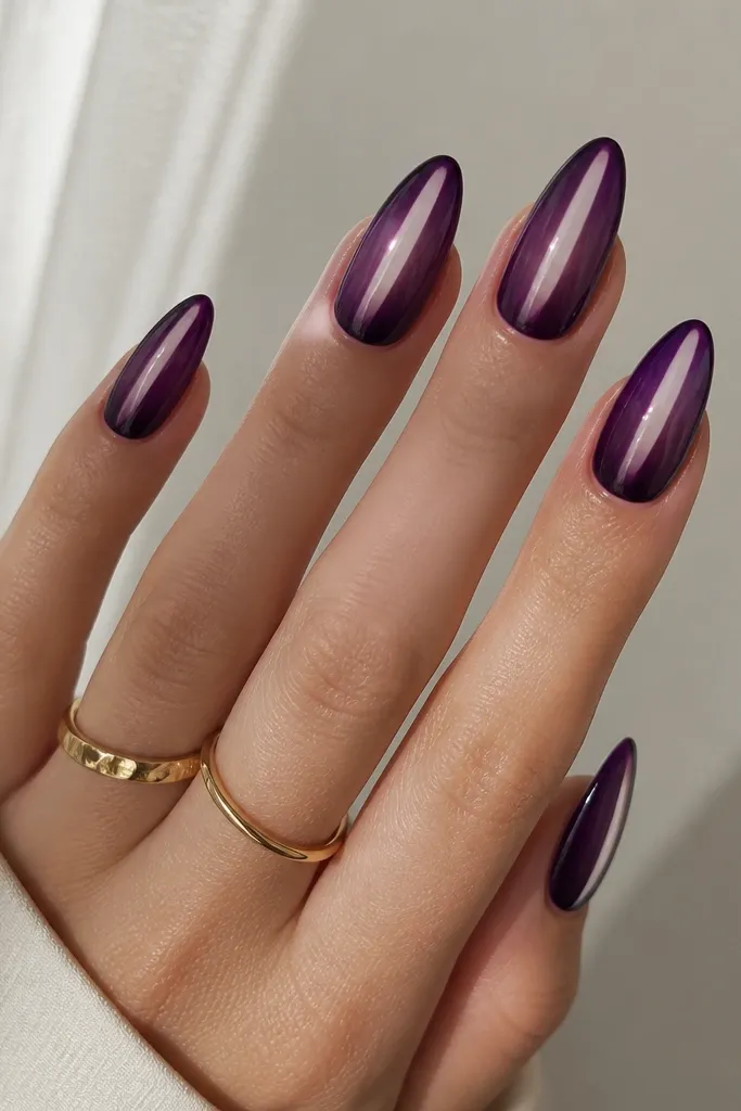 Almond nails with deep purple ombre from tip toward mid, leaving a narrow clear strip down the center, glossy finish like a see-through highlight.
