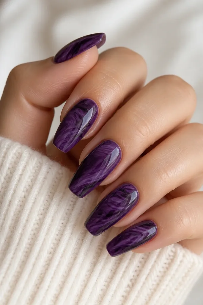 Medium coffin nails with a marbled pattern: dark purple base with lighter plum and near-black swirls. Thin clear jelly streaks run through the marbling like glossy veins. The overall finish is glossy.