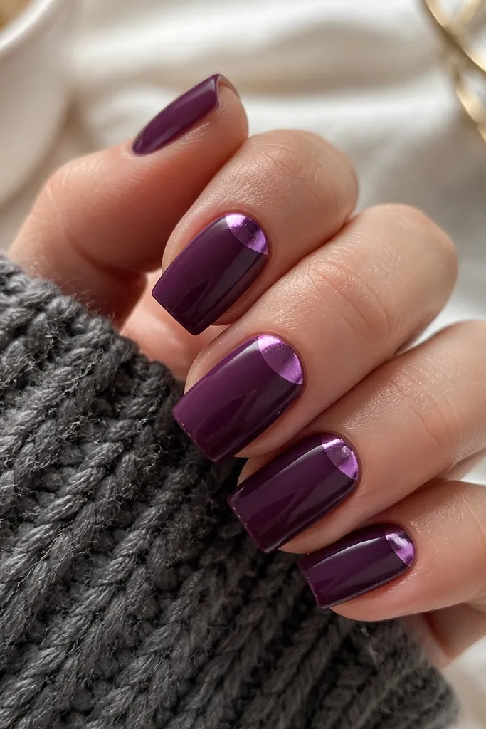 Medium square nails in glossy eggplant purple; each nail has a metallic purple chrome half-moon at the cuticle, leaving the rest glossy solid color.