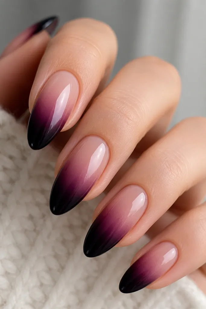 Almond nails with a smooth gradient: nude-to-berry purple in the middle and deep black-purple at the tips, glossy finish.