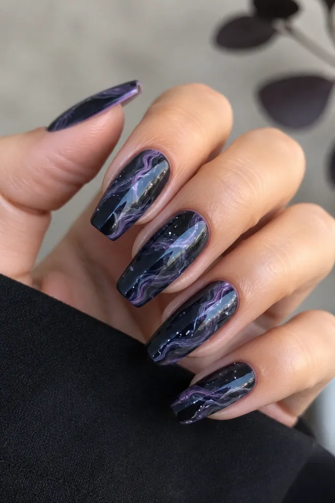 Medium coffin nails with black-purple marble veining on a dark base; tiny pearl-white micro-dots sit near the swirls, glossy finish.