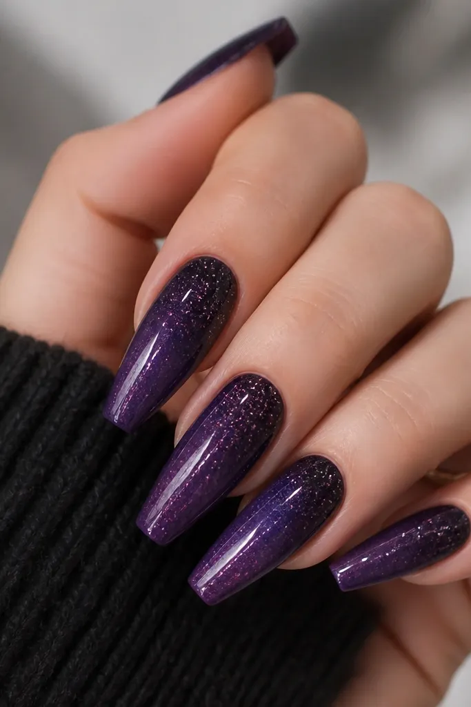 Coffin nails with a smooth dark purple glaze fade from cuticle to tip; a clear top layer with fine silver sparkle sits over the whole nail, glossy.
