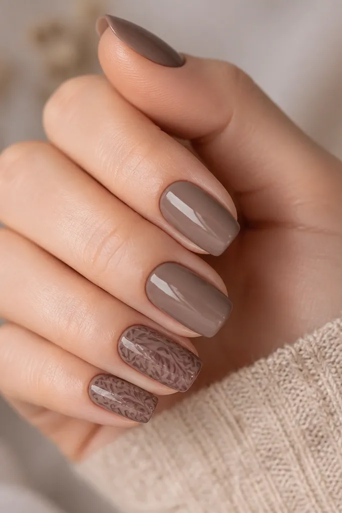 Medium nails painted smoky taupe. On two accent nails, rosewood stamping patterns appear like swirling leaves and lines. Glossy finish.
