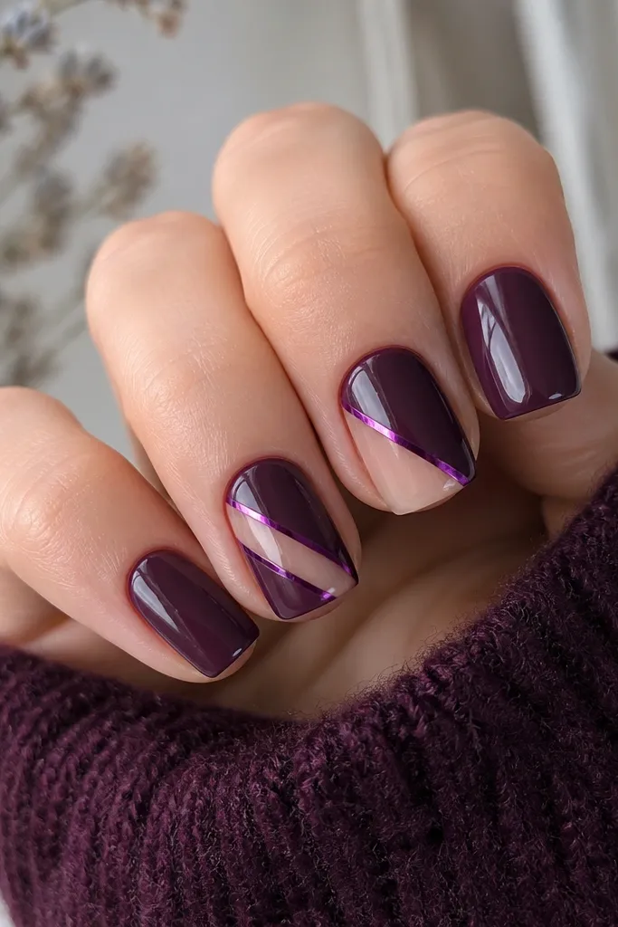 Short squoval nails with a dark purple base. Two nails have diagonal negative-space lines, and thin purple foil strips run along the cutout edges.