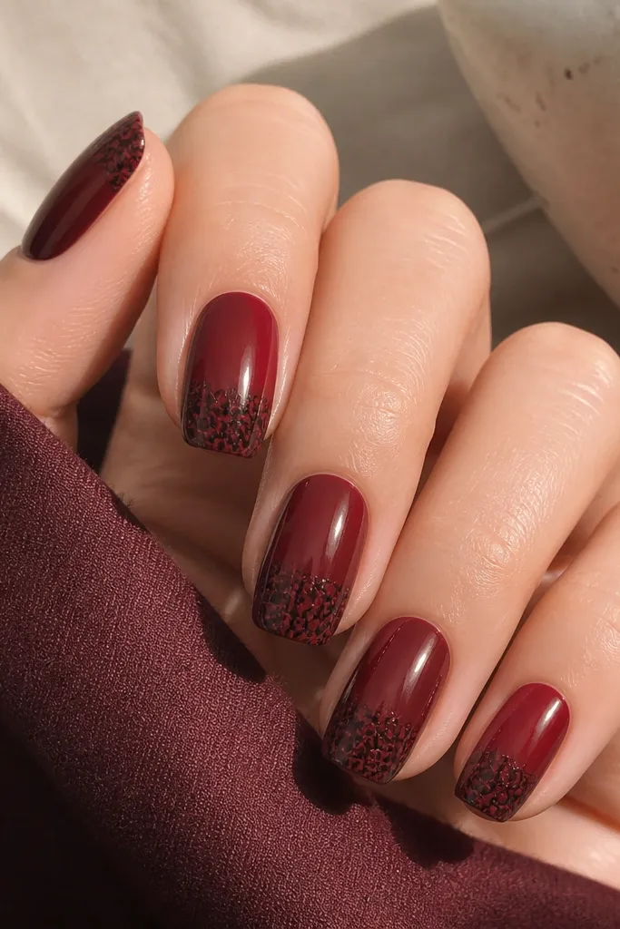 Oxblood nails with black crackle effect concentrated only on the tips. The crackle lines are visible and dense, while the rest of the nail stays smooth red.