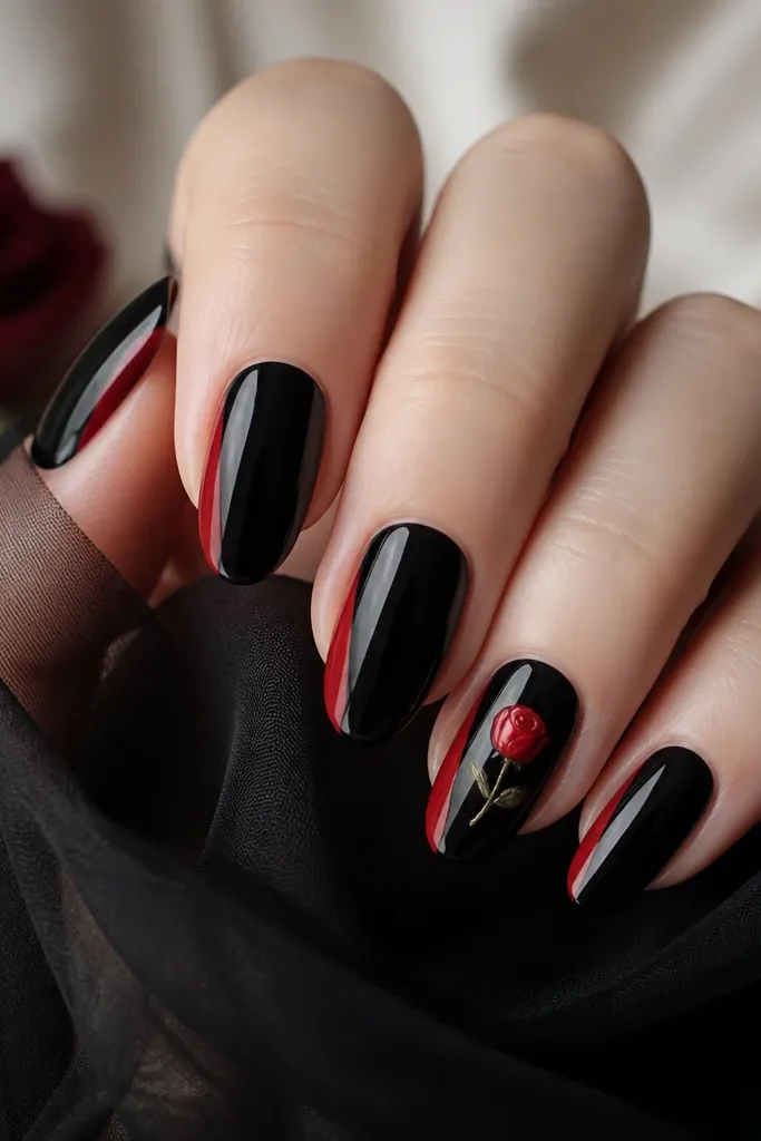 Each nail has a glossy black base with a thin vertical red side panel on one side. On the ring finger, there's a small red rosebud with green-ish tiny accents.