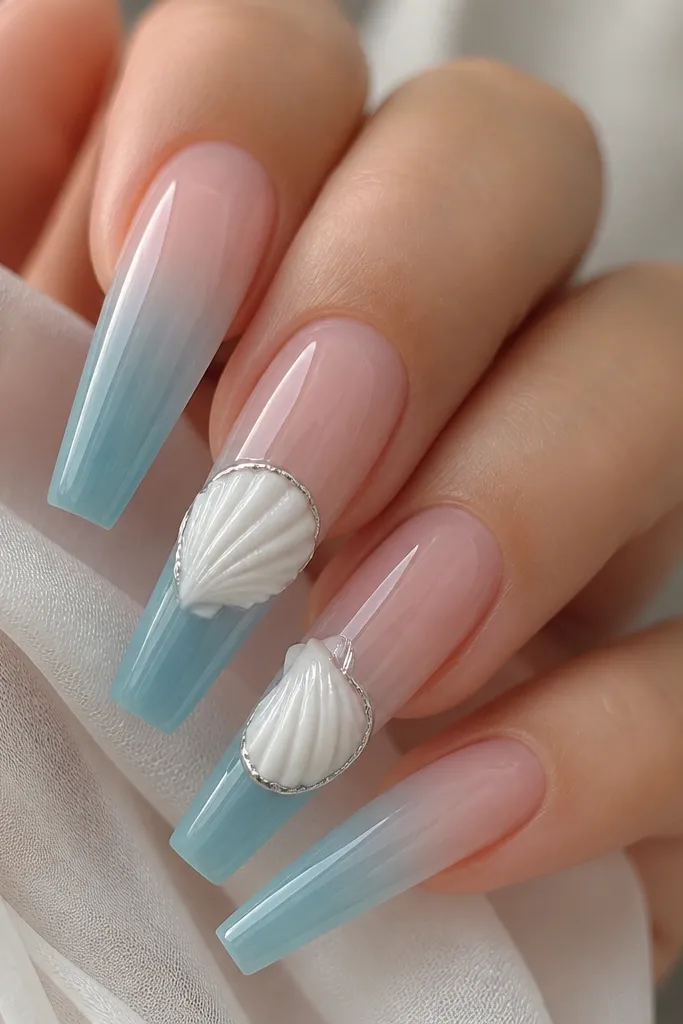 Long coffin nails with a jelly gradient from clear at the cuticle to mermaid blue at the tips. Two nails have 3D white shells with delicate ridges and a thin line of silver chrome along the shell lip.