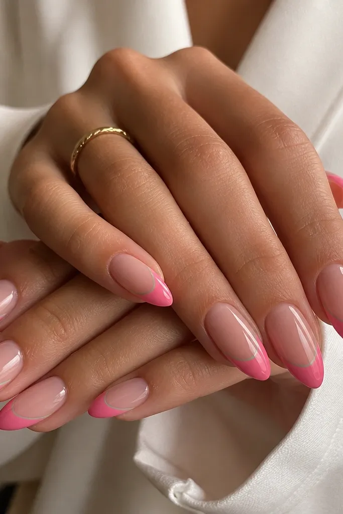 Almond nails with a nude base fading into a bright watermelon pink at the tips; a thin mint green line separates pink and a tiny white highlight curve on two nails.