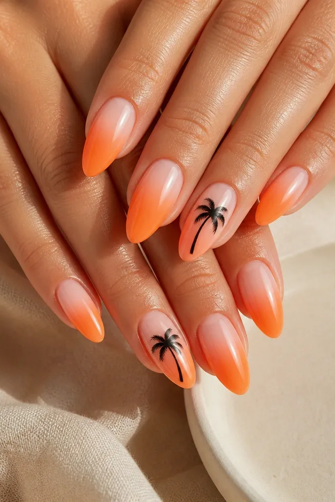 Almond nails in a warm orange-to-sheer gradient; two accent nails show a black palm tree silhouette near the center; glossy top coat.
