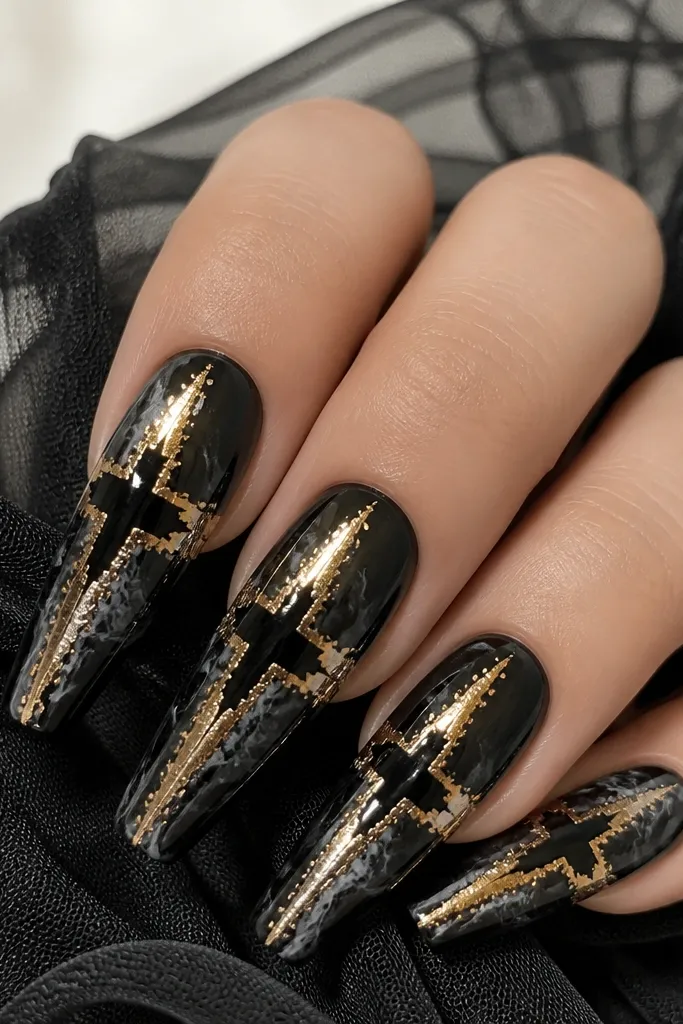 Long coffin nails with black marble swirls. A gold foil cross shape sits on each nail - one vertical and one horizontal arm - with foil concentrated along the cross edges. The center of the cross is mostly black.