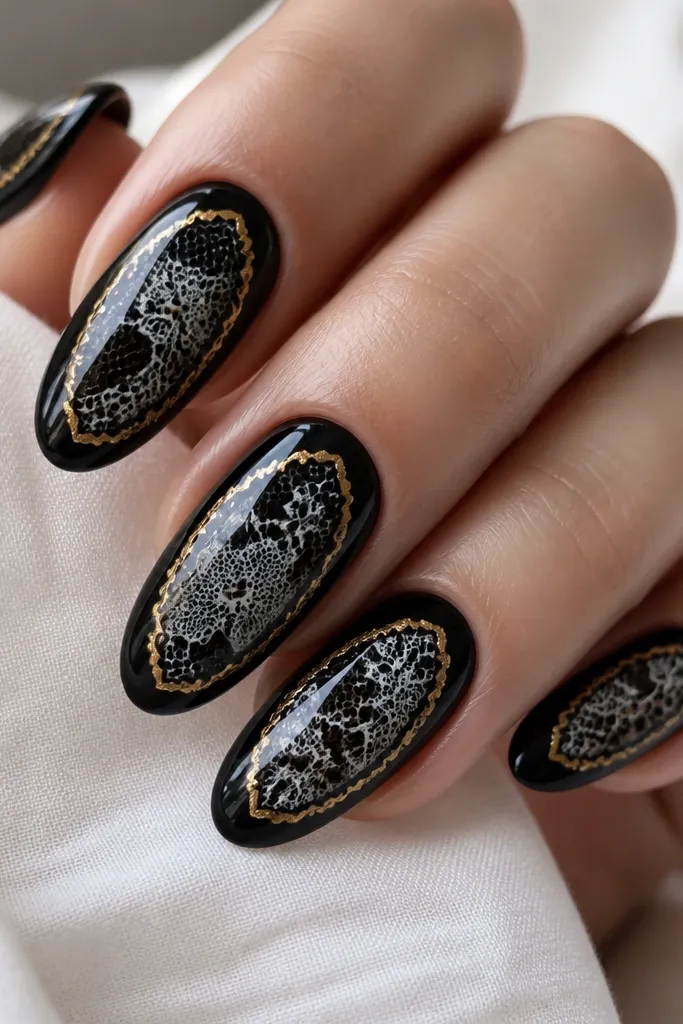Nails with black base and white/gray lace stamping patterns that look like delicate lines. Around the lace area sits a thin gold foil frame border. The overall finish is glossy and crisp.