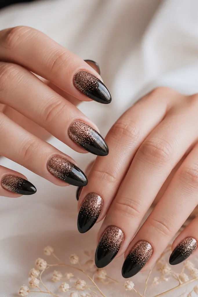 A smooth gradient from solid black at the base fading into a rose-gold glittery tip. The transition is soft, not streaky, and the tips look like a glitter wash.