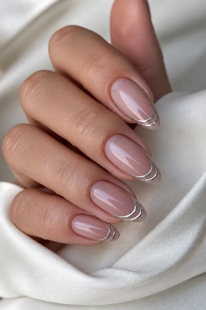 Almond nails with a nude-to-mauve ombre from cuticle to tip. The French area has two thin silver chrome lines, one on the smile and one slightly above it.