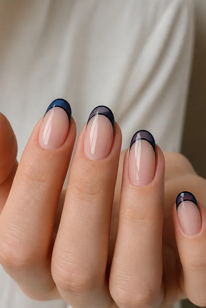 Nude base nails with two-tone French tips: deep navy outline with a sheer navy jelly fill in the tip area, glossy finish.