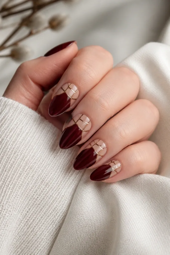 Dark cherry red nails with a mosaic pattern: nude tile-like blocks at the upper half separated by thin lines, glossy almond nails.