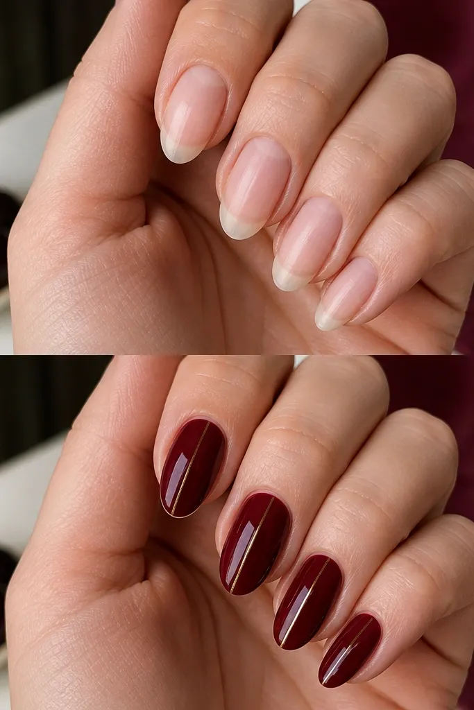 Medium almond nails painted dark cherry red with a single thin gold stripe running down the center of each nail. The gold line is straight and glossy, with minimal decoration. The rest of the nail is solid cherry red and mirror-like.