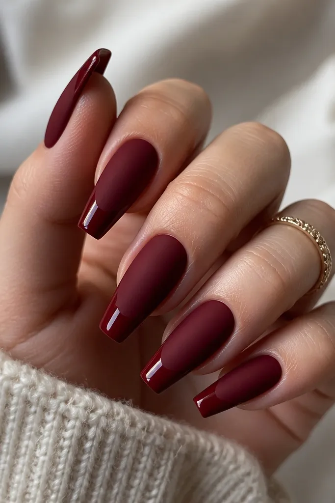 Coffin nails with matte dark cherry red on the main nail and a glossy dark cherry red cap on the tip, creating a two-finish look.