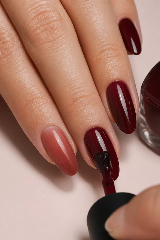 A set of nails with three visible layers effect: the first coat is semi-sheer, the second coat looks evenly opaque, and the final coat is fully glossy; each nail is smooth with no ridges.