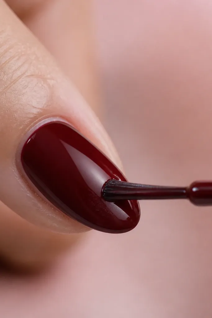 A nail with a faint streak after the first coat; the fix shows an even second coat with a smooth finish and no visible stripe.