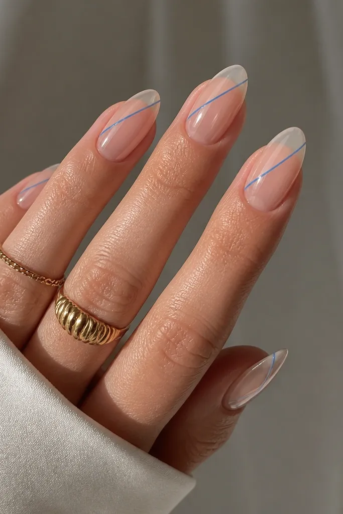 Clear glossy almond nails with a single thin blue line-art stroke running diagonally from near the cuticle toward the tip on each nail.