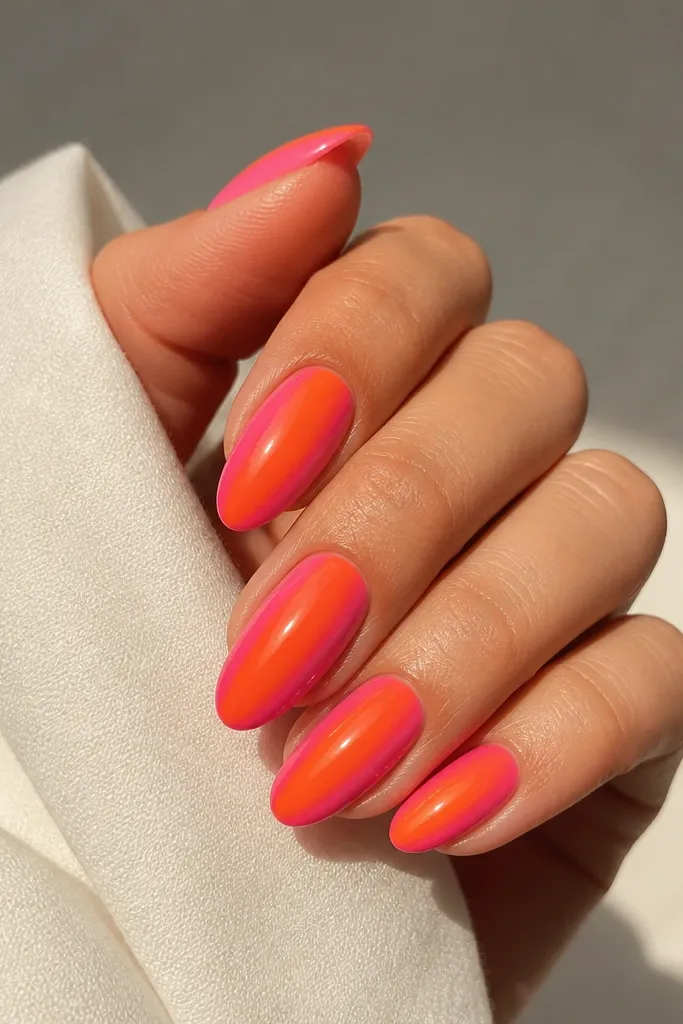 Almond nails with orange center stripe and hot pink gradient on both sidewalls, glossy finish.