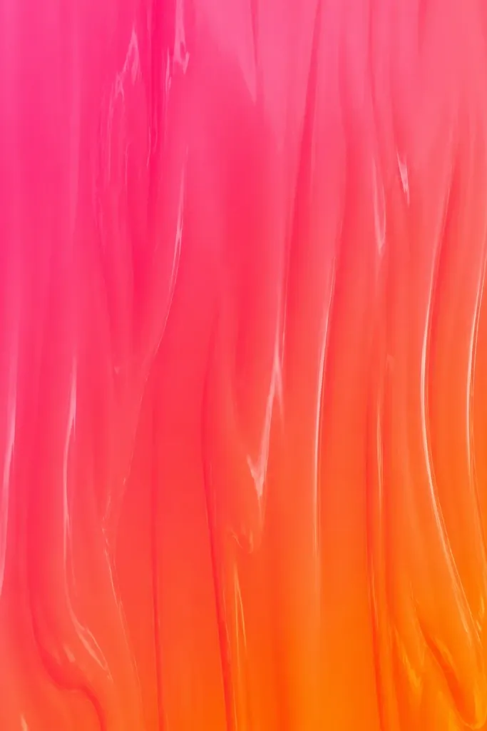 A glossy gradient that looks like neon paint flowing downward: hot pink on the left and top transitions into neon orange near the bottom. The transition is smooth with a slight streak effect.