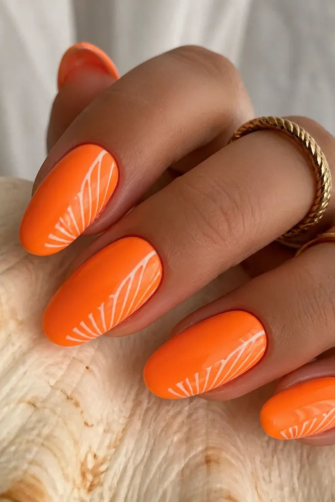 Medium almond nails in a bright neon-orange. Thin calm white shell ridges curve from the side toward the center, with a few small gaps for a breathable pattern. Glossy topcoat.