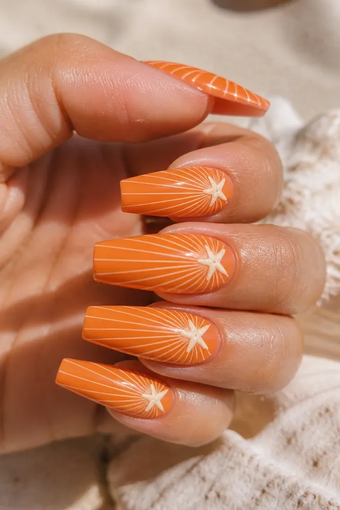 Long coffin nails in bright orange. A burst of white shell ridges radiates from the center, and one small pale starfish silhouette sits near the cuticle. Glossy topcoat.
