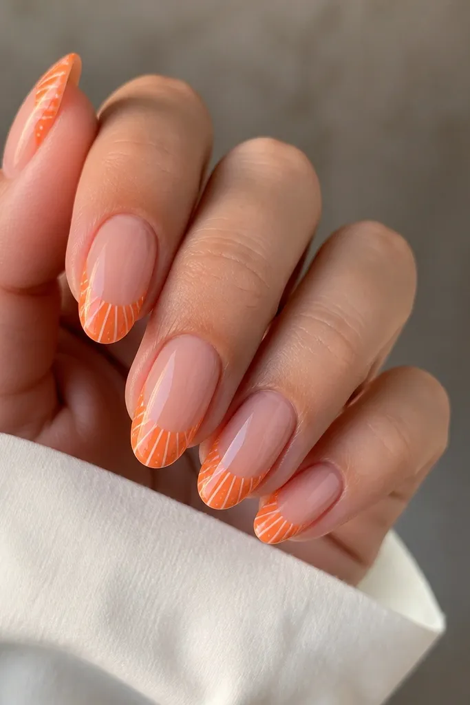Short almond nails with bright orange French tips. Inside the tip area are white shell ridges plus scattered micro peach dots. Glossy topcoat.