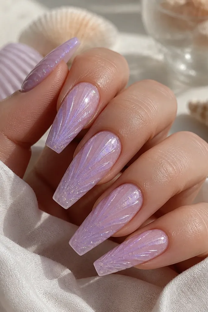 Long coffin nails. Base is sheer purple with a sea-glass look. Shell ridges are semi-transparent lavender. Tiny holographic micro glitter specks are scattered lightly around the ridges. Glossy topcoat.