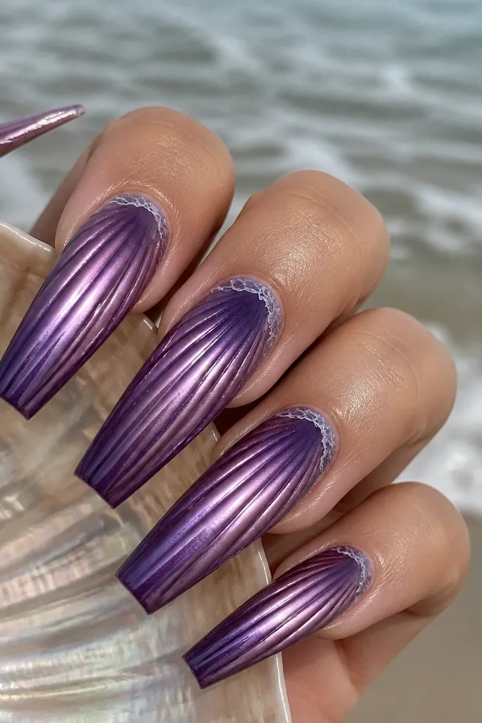 Long coffin nails. Base is deep purple. Shell ridges are buffed with purple chrome powder so they look mirror-smooth. The chrome fades from bright on the ridges to softer on the base, with a tiny milky foam line at the edge.