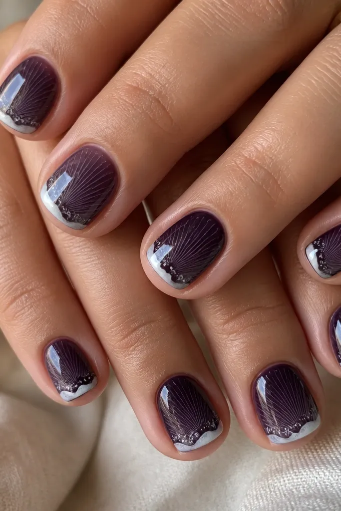 Short square nails. Base is dark grape. Shell ridges are made from tiny white micro-lines inside the purple area. A single milky white foam edge runs along the outer side. Matte-to-gloss topcoat shine.