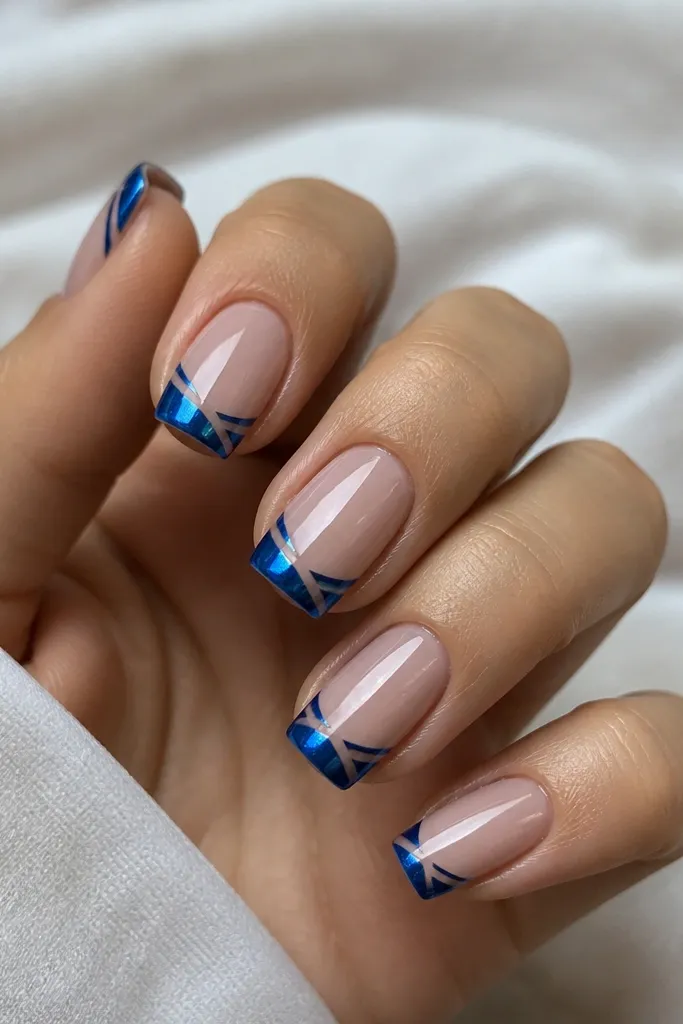 Square nails with a blue chrome French tip; a narrow negative-space diagonal slash cuts through the French area, exposing nude underneath; clean geometric look, mirror shine.