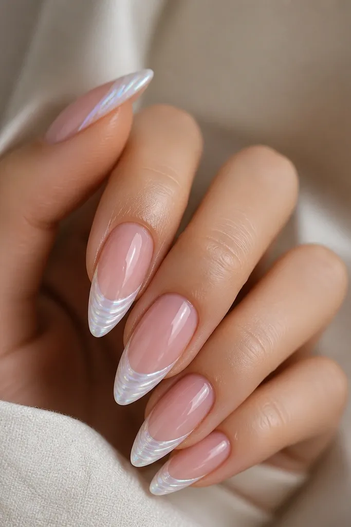 Almond nails with a sheer pink base. The French tips are bright white and crisp. Inside each tip are opal-like ridges: thin lines in white with hints of lavender and aqua shimmer, catching light at different angles.